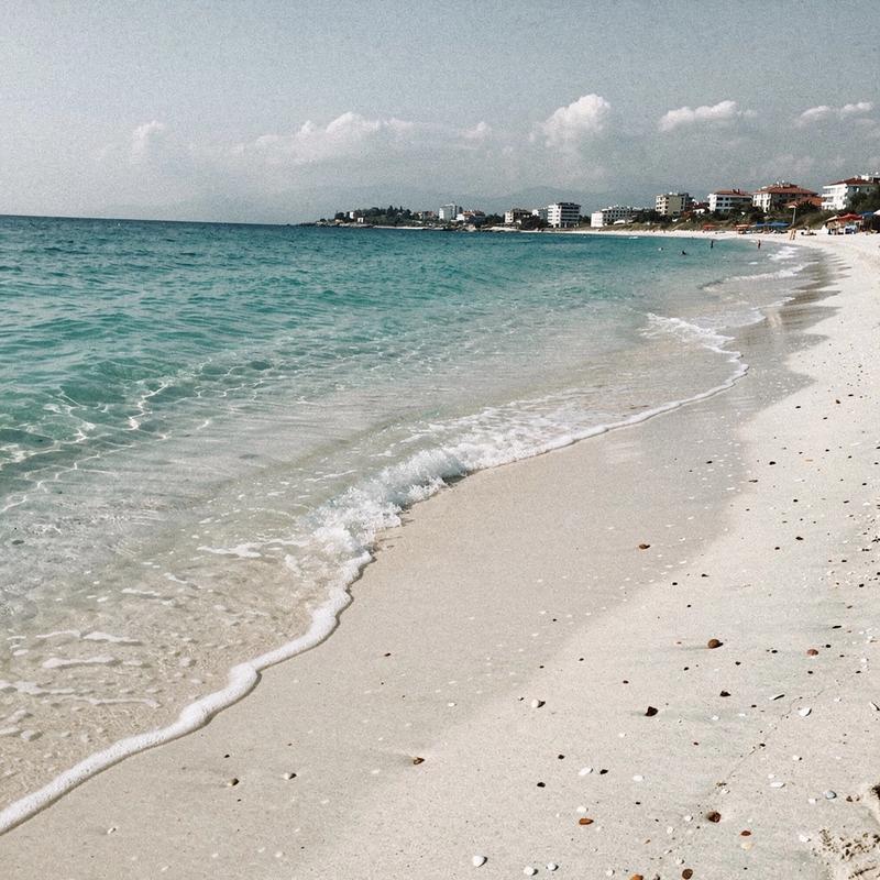 Shallow water over pale sand at an Antalya family beach